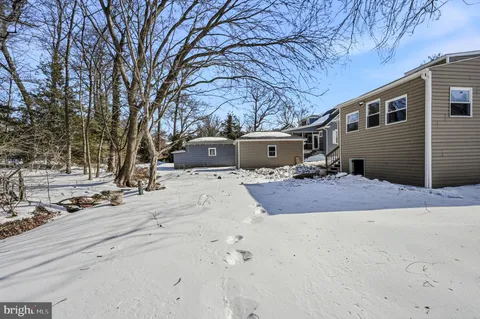 a view of a house with snow on the road