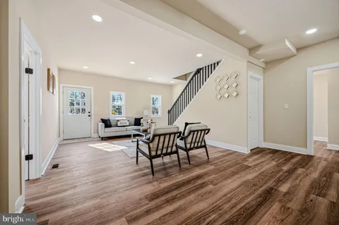 a view of a livingroom with furniture stairs and windows