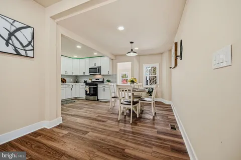 a view of a kitchen with dining table and chairs