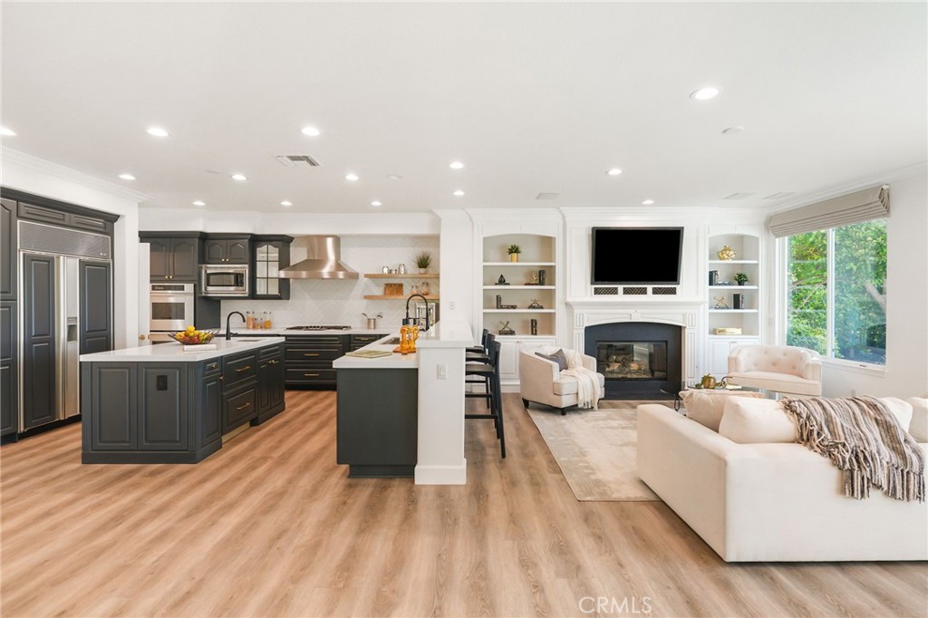 20112 Vía Cellini Porter Ranch, CA 91326 - Photo 14 of 64 a living room with furniture a fireplace and a television