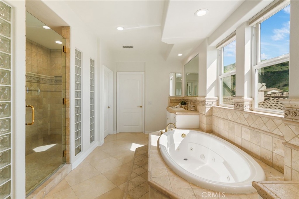 20112 Vía Cellini Porter Ranch, CA 91326 - Photo 33 of 64 a large bathroom with a large tub shower and sink