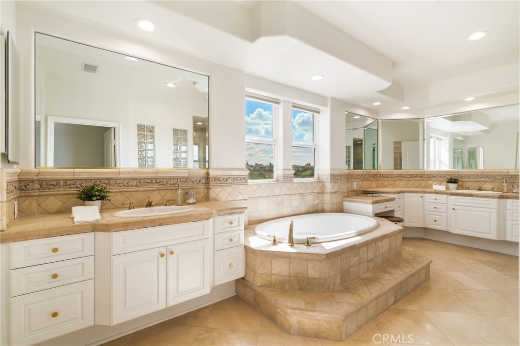 20112 Vía Cellini Porter Ranch, CA 91326 - Photo 34 of 64 a spacious bathroom with a tub double sink and mirror