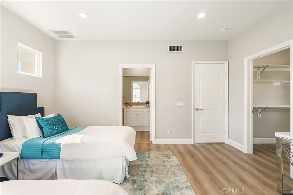 20112 Vía Cellini Porter Ranch, CA 91326 - Photo 45 of 64 a bedroom with a bed and wooden floor