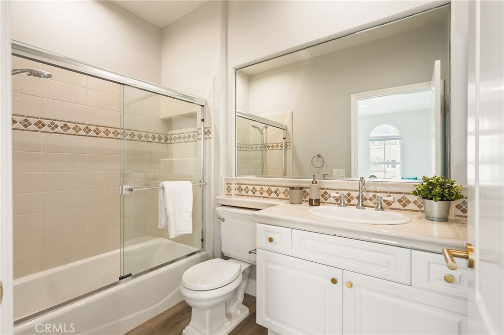 20112 Vía Cellini Porter Ranch, CA 91326 - Photo 46 of 64 a bathroom with a sink a toilet and a mirror