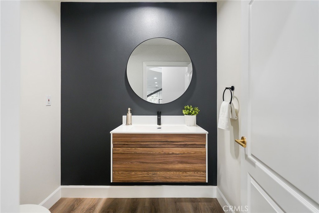 20112 Vía Cellini Porter Ranch, CA 91326 - Photo 49 of 64 a bathroom with a sink a mirror and a light fixture