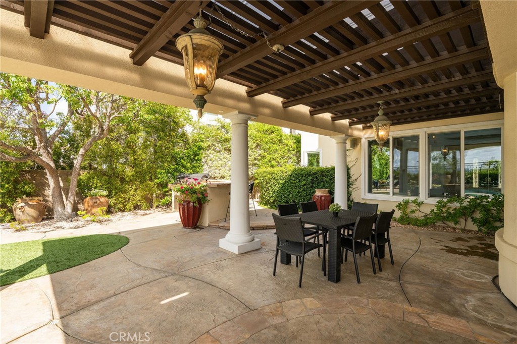 20112 Vía Cellini Porter Ranch, CA 91326 - Photo 61 of 64 a view of a porch with dining table and chairs