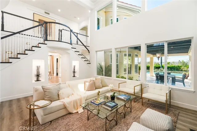 a living room with patio furniture and a large window