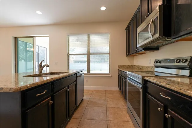 a view of a kitchen with a sink and cabinets