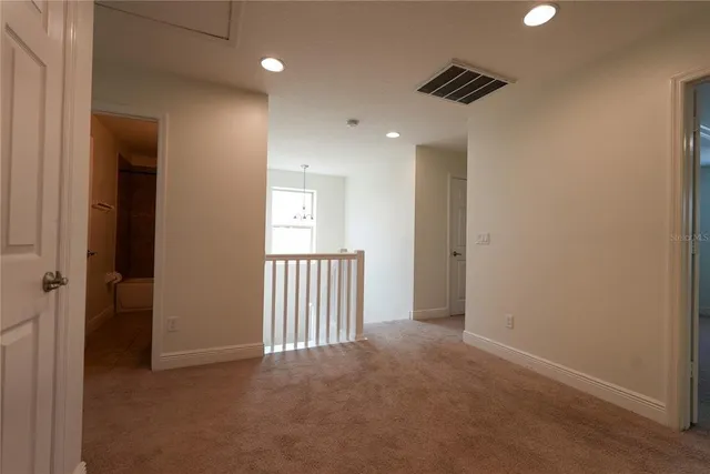 an empty room with closet and a bathroom