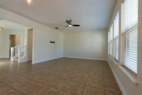 a view of a livingroom with a ceiling fan and window