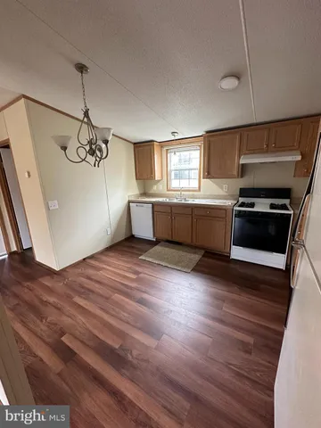 a kitchen with a refrigerator and a stove top oven