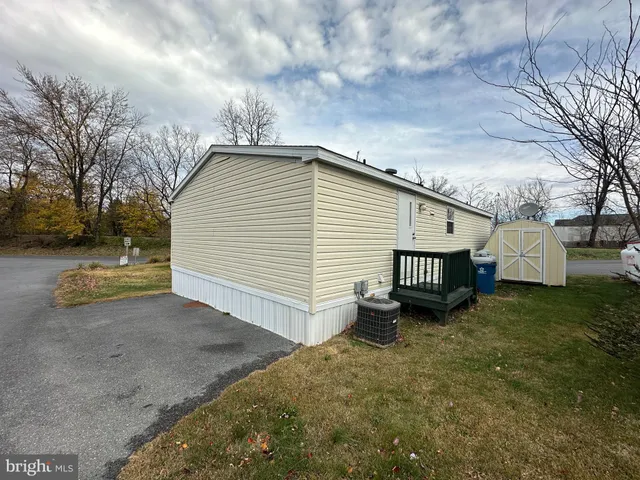 a view of a house with a yard and fence