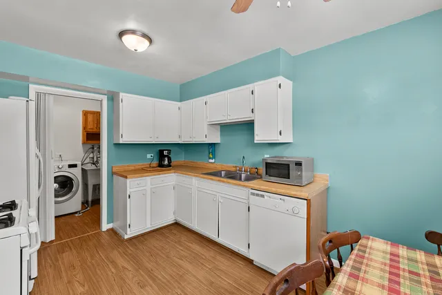 a kitchen with a sink a stove and cabinets