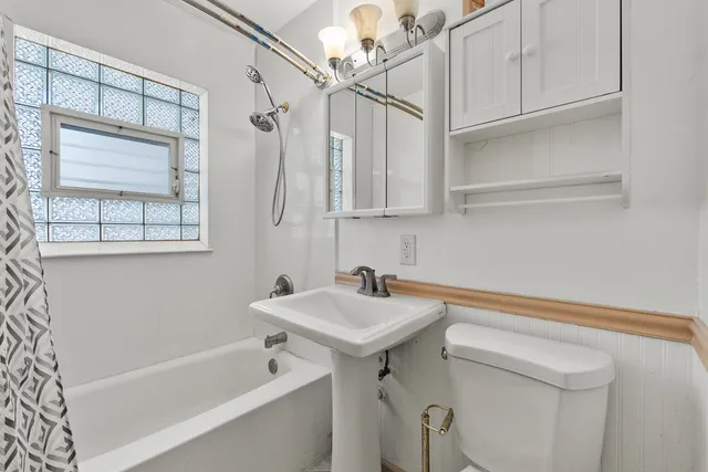 a bathroom with a sink a mirror and a bathtub
