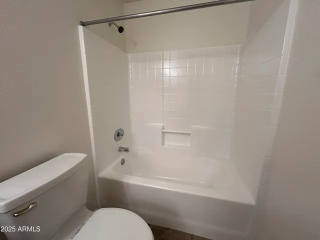 a bathroom with a toilet and a bathtub