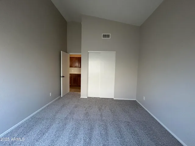 a view of an empty room with closet
