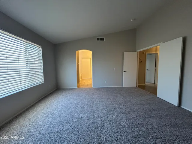 a view of an empty room with a window