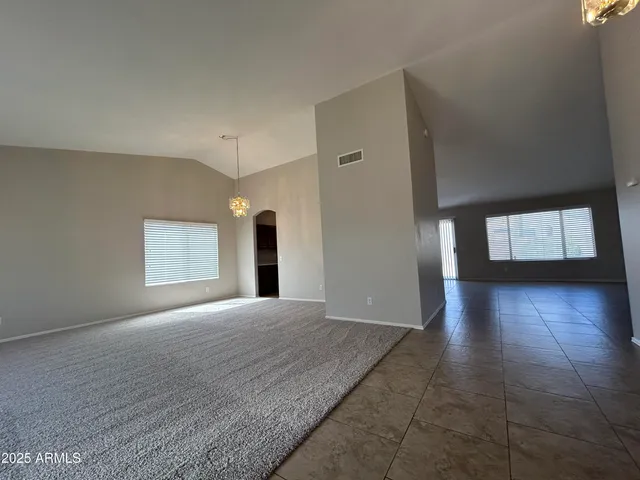 a view of a hallway with wooden floor and a window