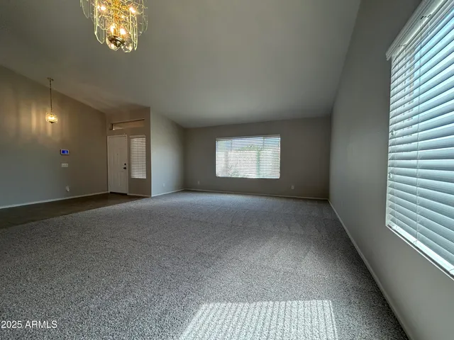 a view of an empty room and a window