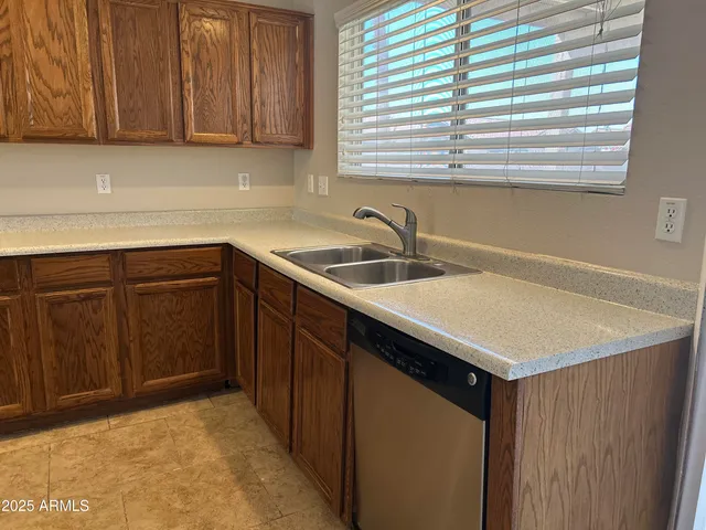 a kitchen with a sink cabinets and window
