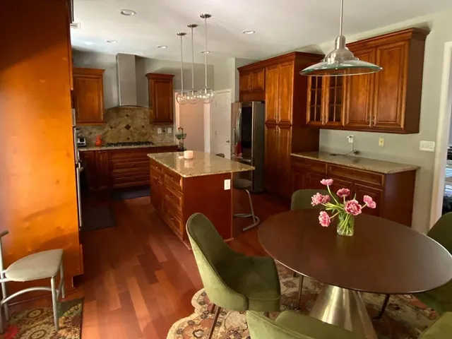 a kitchen with stainless steel appliances granite countertop a stove a sink and a refrigerator