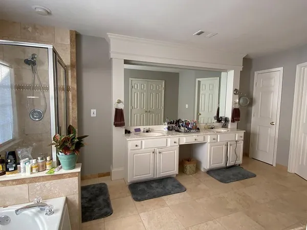 a room with a sink and a refrigerator