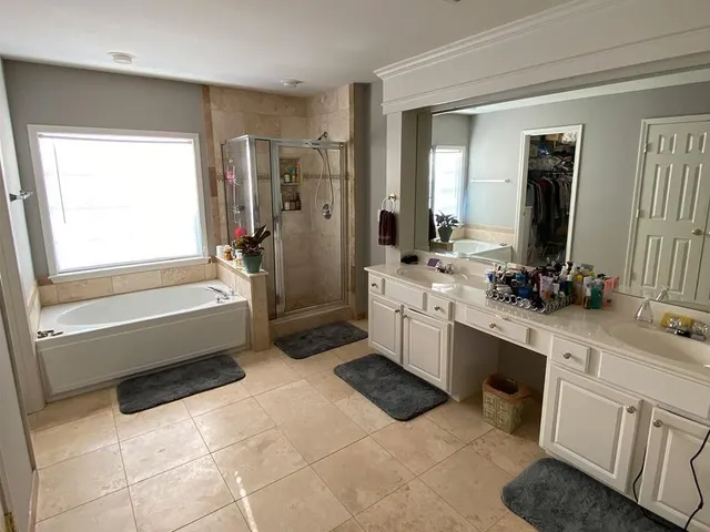 a bathroom with a bathtub sink and mirror