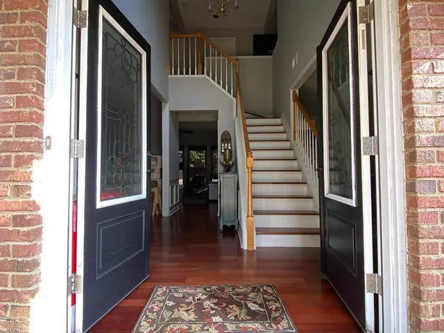 a view of entryway with stairs and wooden floor