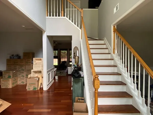 a view of entryway and hall with wooden floor