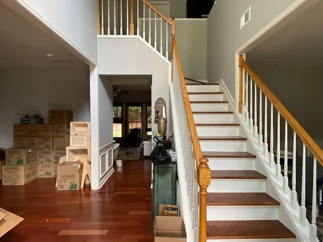 a view of entryway and hall with wooden floor