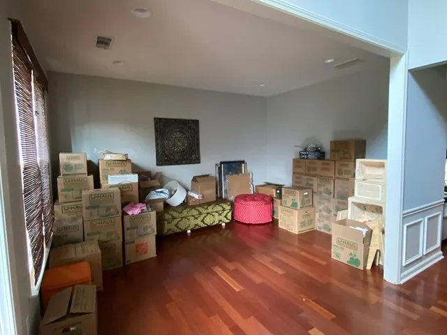 a bedroom with furniture and wooden floor