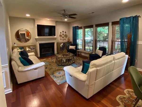 a living room with fireplace furniture and a flat screen tv