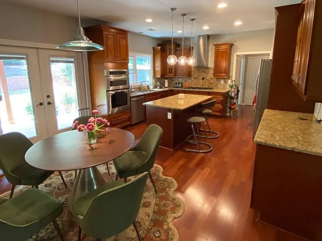 a dining room with furniture and a chandelier