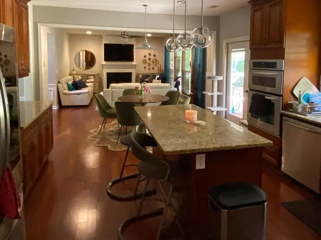 a view of a dining room with furniture and chandelier