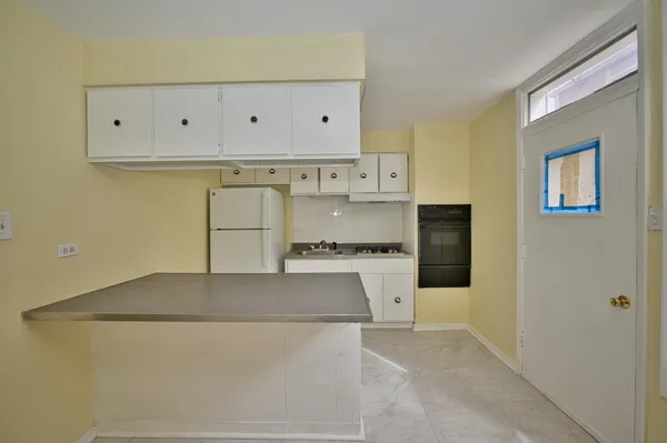 a view of kitchen with stainless steel appliances cabinets