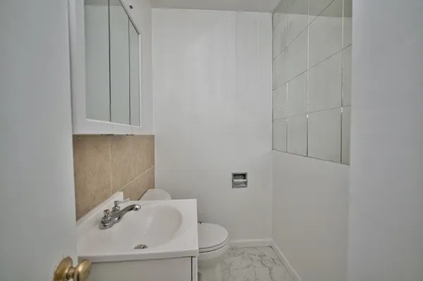 a bathroom with a sink and toilet