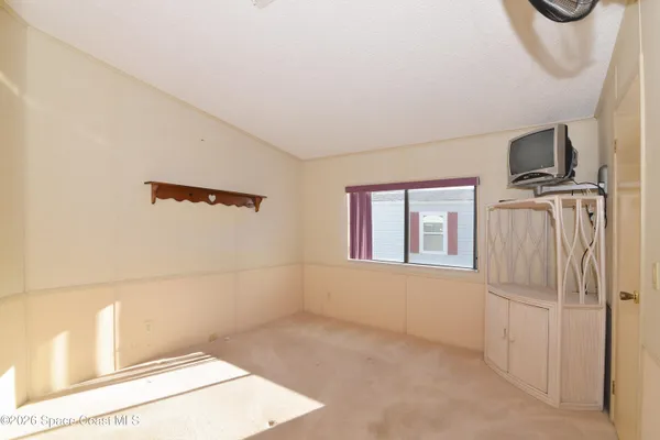 a view of a livingroom with a kitchen