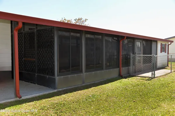 a view of house with backyard and glass area