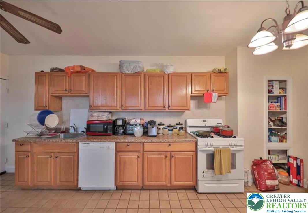 926 Butler Street Easton, PA 18042 - Photo 2 of 6 a kitchen with stainless steel appliances a stove a sink and cabinets