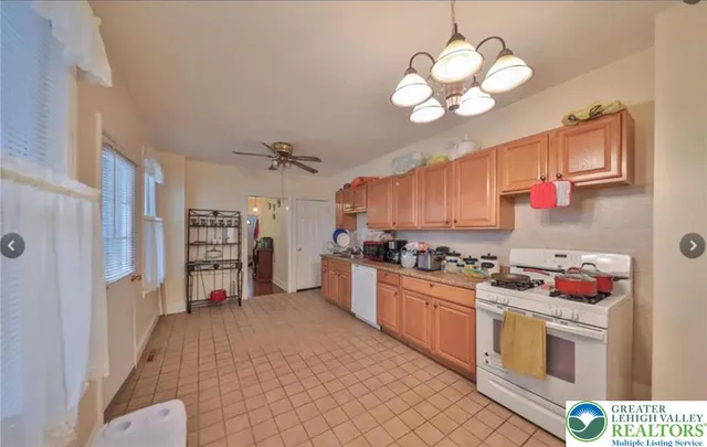 a kitchen with stainless steel appliances granite countertop a stove cabinets and wooden floor