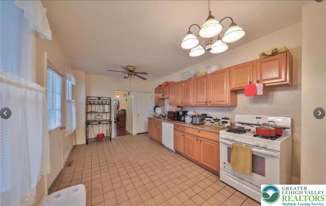 926 Butler Street Easton, PA 18042 - Photo 3 of 6 a kitchen with stainless steel appliances granite countertop a stove cabinets and wooden floor