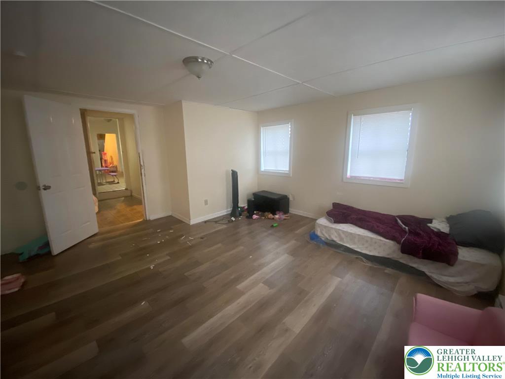 926 Butler Street Easton, PA 18042 - Photo 4 of 6 a bedroom with a bed and wooden floor