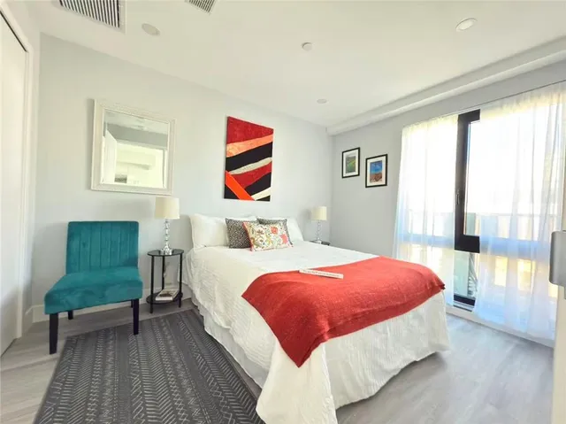 a bedroom with two beds and a chair