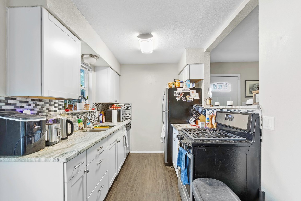 2003 Conestoga Trail, Unit B Austin, TX 78744 - Photo 7 of 18 a kitchen with a stove and a sink