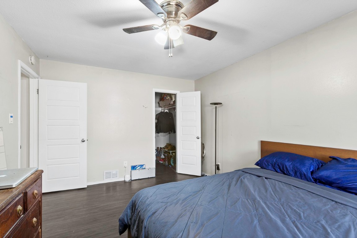 2003 Conestoga Trail, Unit B Austin, TX 78744 - Photo 10 of 18 a bedroom with a bed and wooden floor