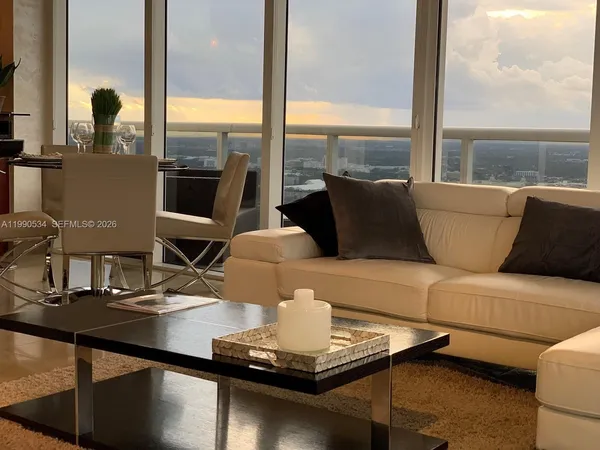 a living room with furniture and a large window