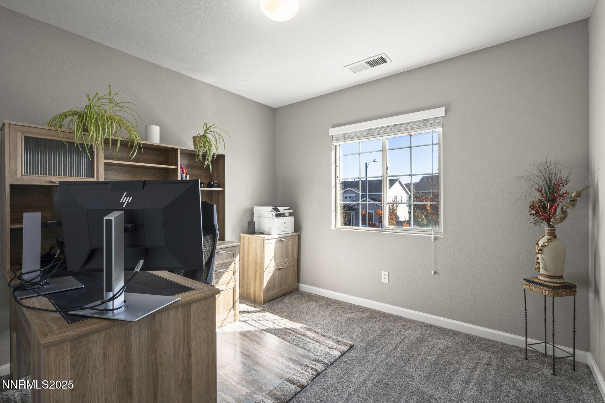 8963 Wynne Street Reno, NV 89506 - Photo 22 of 32 a living room with furniture a flat screen tv and a window