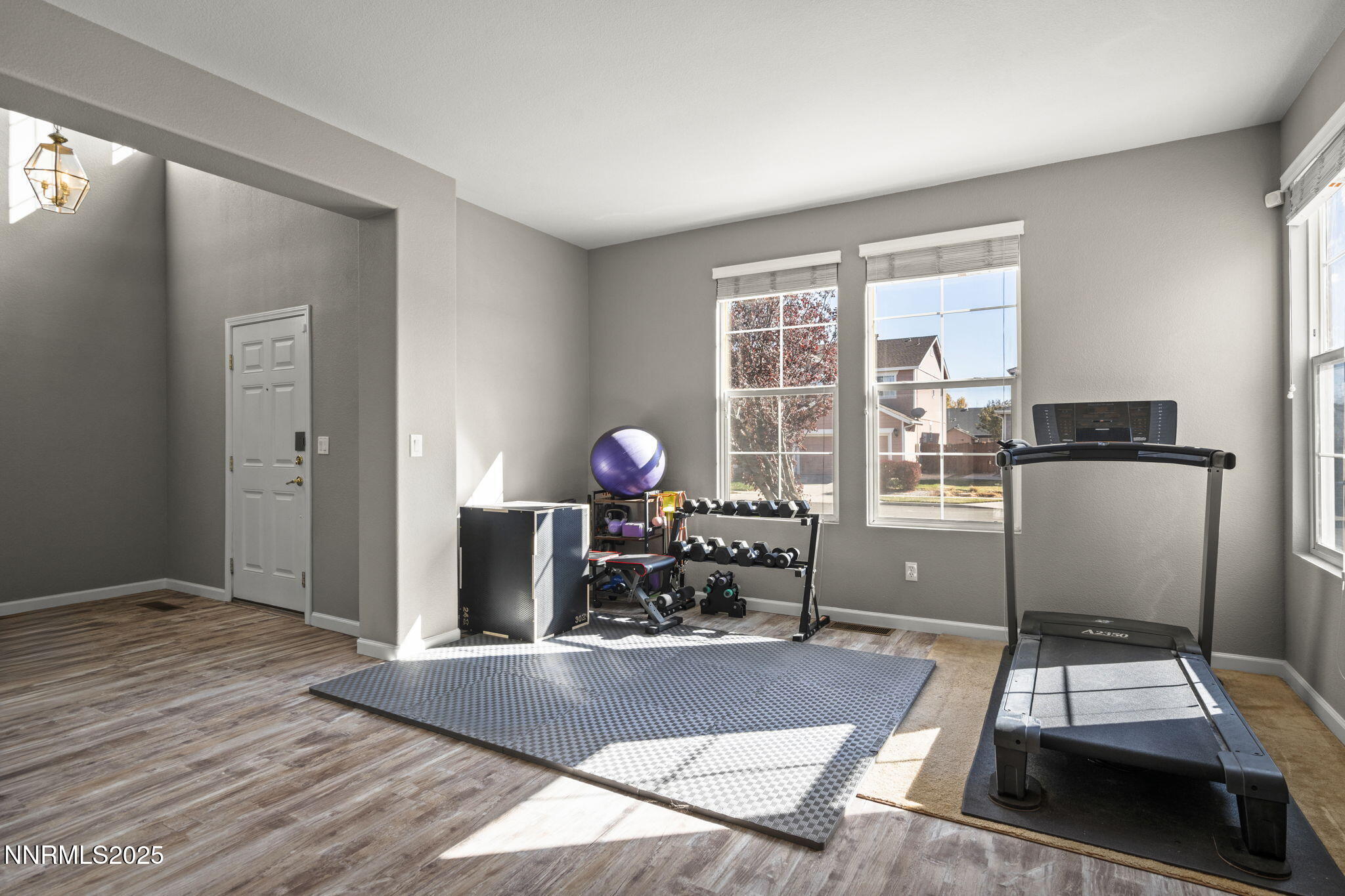 8963 Wynne Street Reno, NV 89506 - Photo 6 of 32 a living room with furniture a flat screen tv and a floor to ceiling window