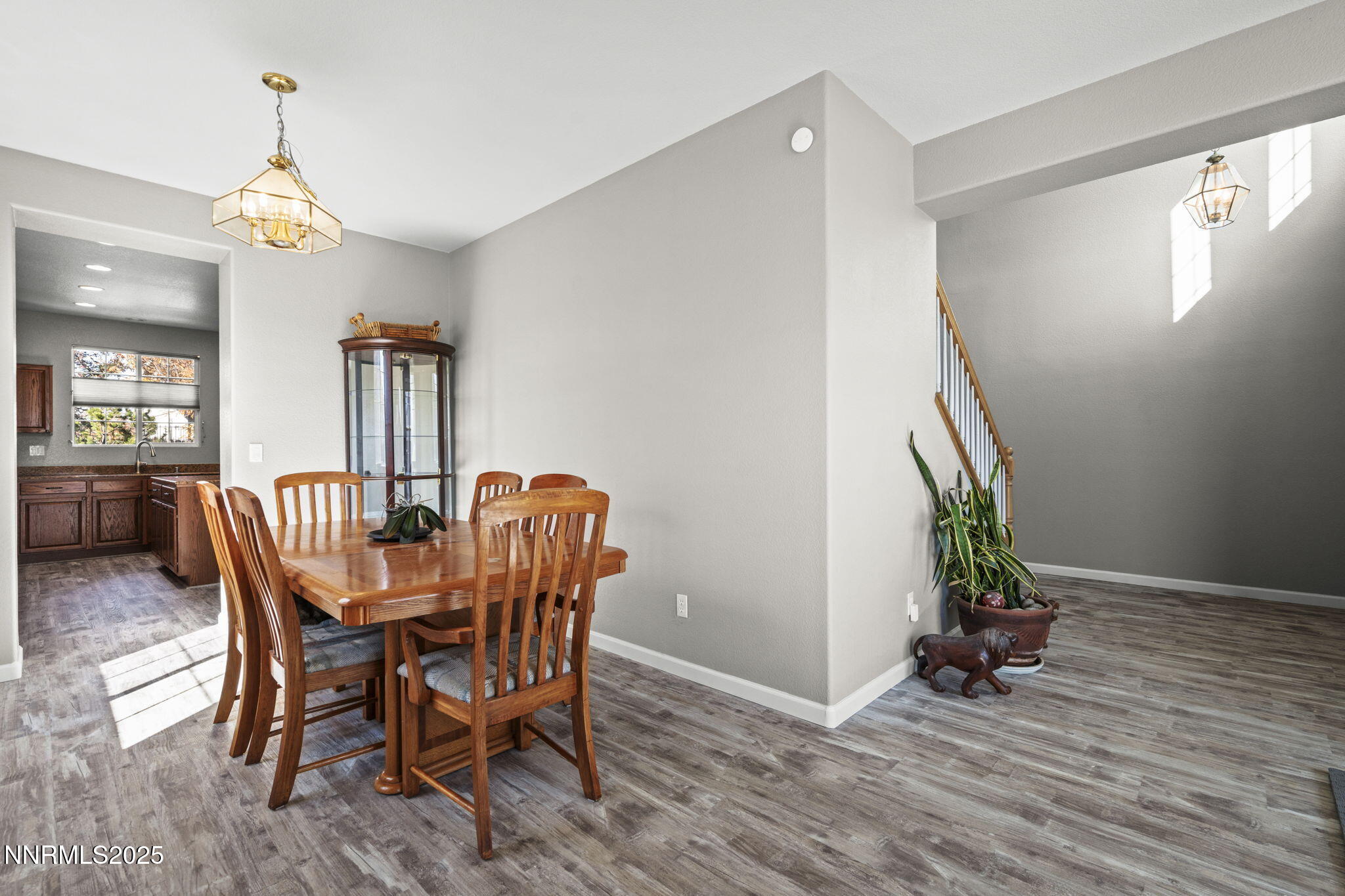 8963 Wynne Street Reno, NV 89506 - Photo 7 of 32 a dining room with furniture potted plants and wooden floor