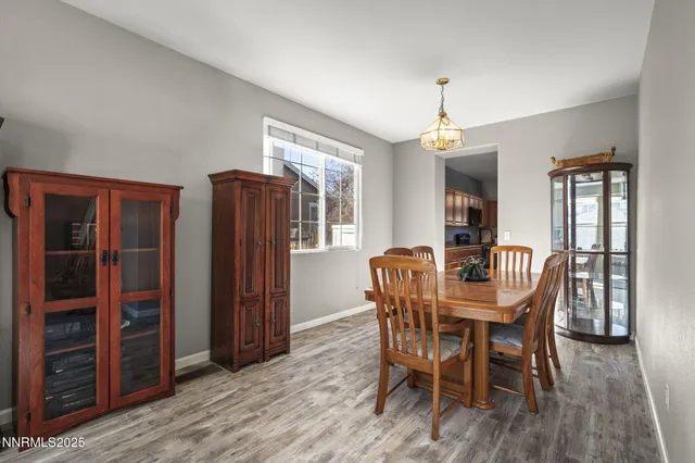 a dining room with furniture window and wooden floor